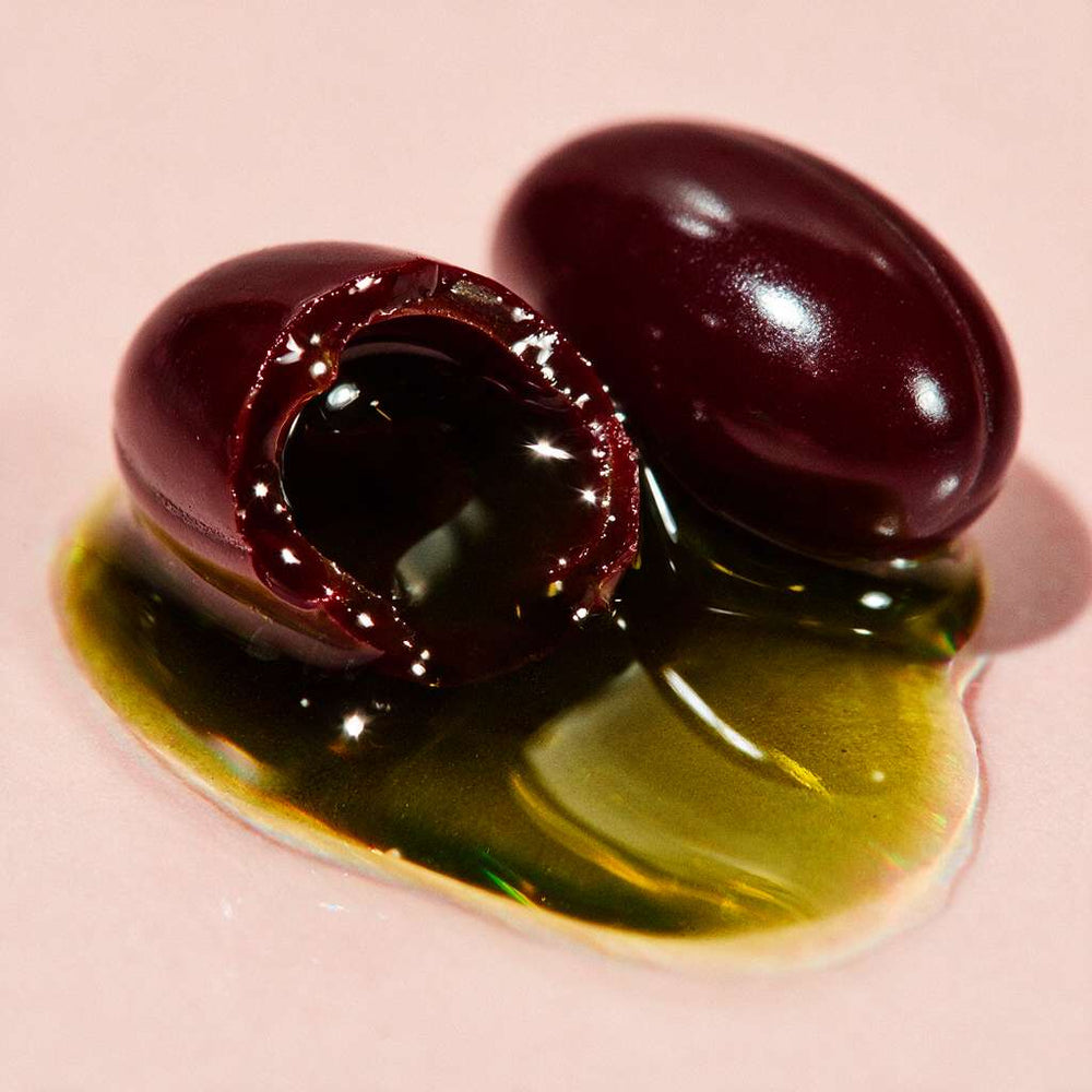 A softgel cut open showing pumpkin seed oil